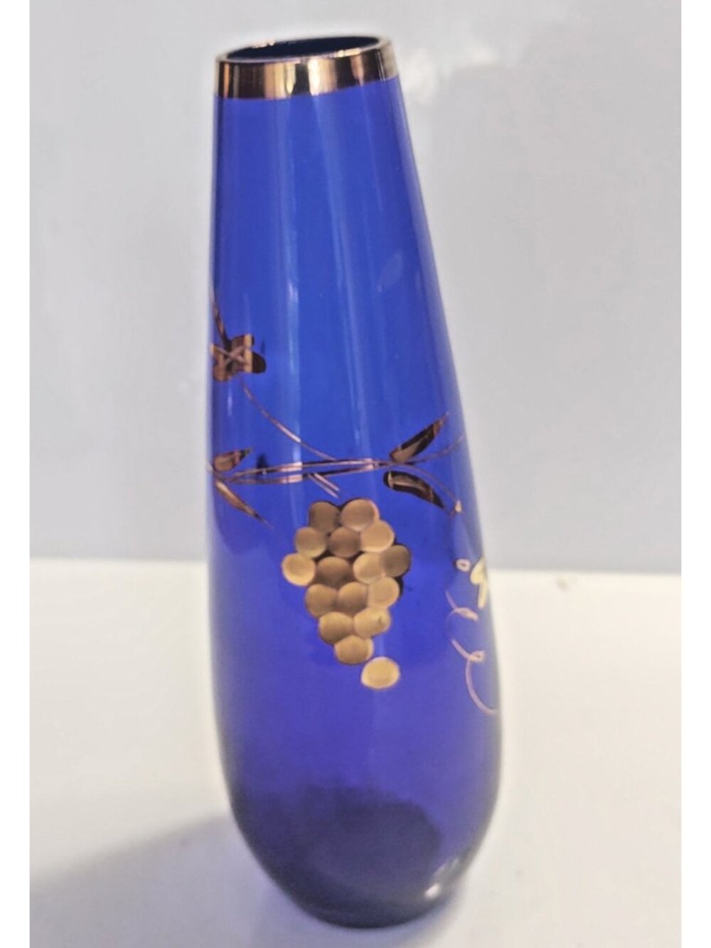 Vintage cobalt blue glass vase featuring a hand-painted gold-accented grape 8"